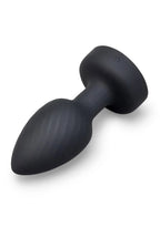 A matte black silicone butt plug with a flared base and ribbed shaft, shown on a clean white background.